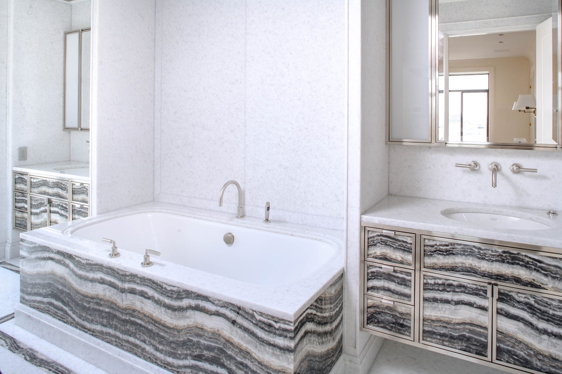 Custom Designs — bathroom with a custom onyx tub surround and vanity